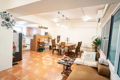 Spacious open-plan living and dining area with cozy decor and tiled flooring.