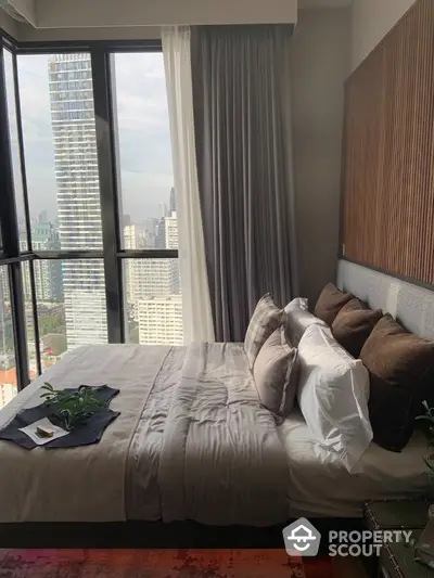 Luxurious bedroom with stunning city view from floor-to-ceiling windows, modern decor and plush bedding.