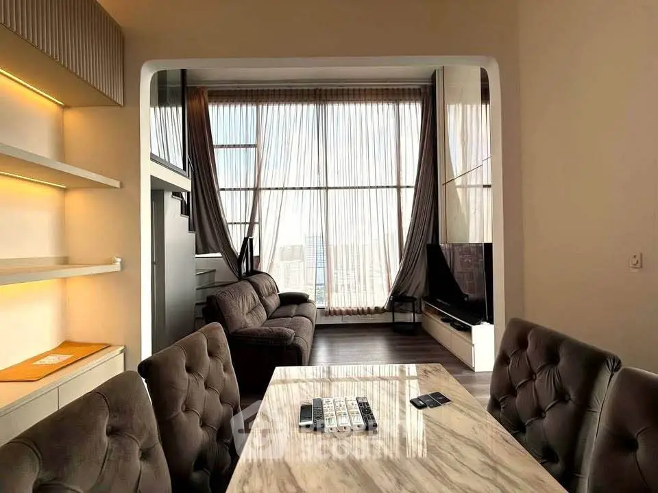 Luxurious living room with high ceilings and modern furnishings, featuring a stunning city view.