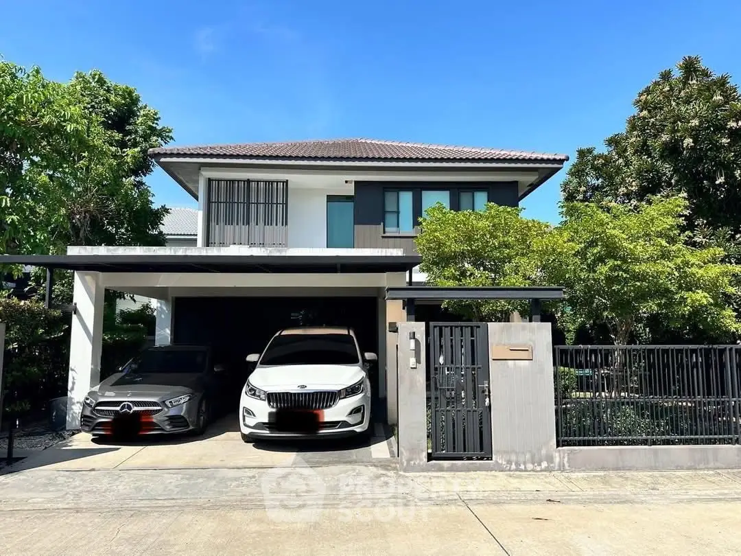 Modern two-story house with carport and lush greenery in a serene neighborhood.