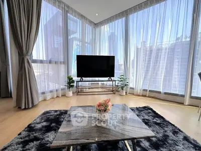 Luxurious corner unit living room with floor-to-ceiling windows and stunning city views.