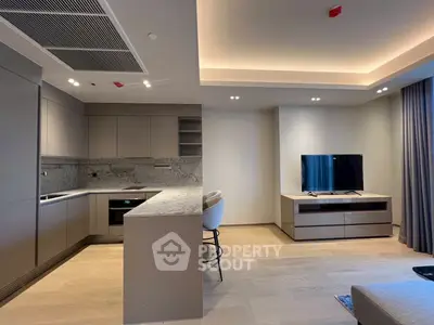 Modern open-plan living room with sleek kitchen and stylish decor