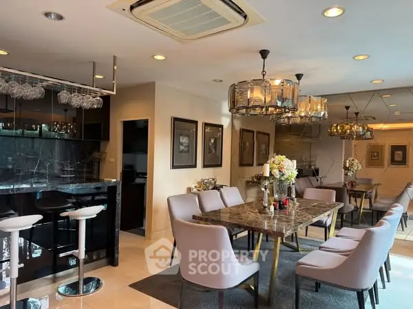 Luxurious dining area with elegant lighting and modern decor in a spacious open layout.