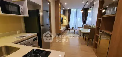 Modern open-layout kitchen and living room with stylish decor and appliances