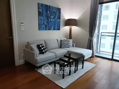 Modern living room with stylish decor and large windows offering city views.