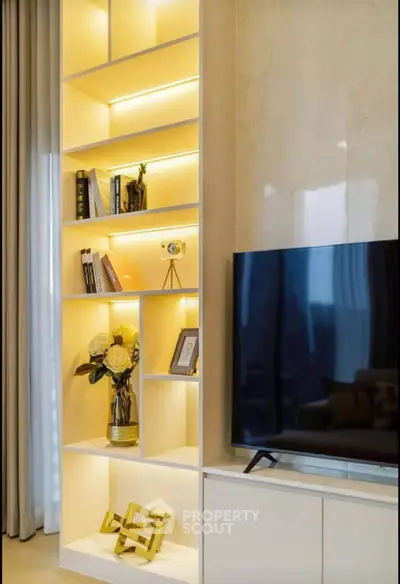 Modern living room with stylish shelving and large TV setup
