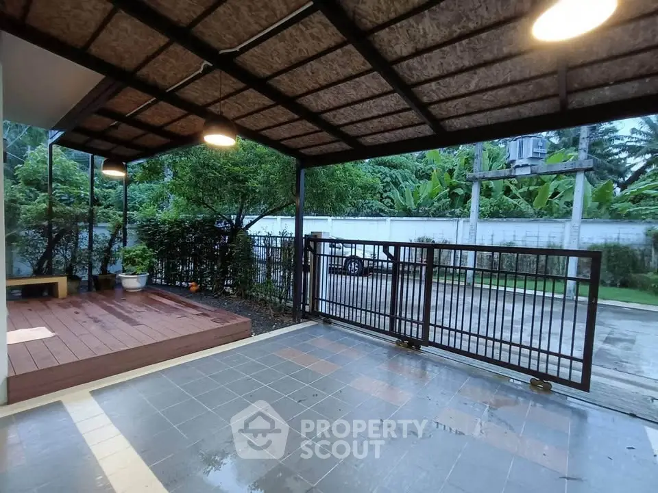 Spacious covered patio with modern lighting and garden view