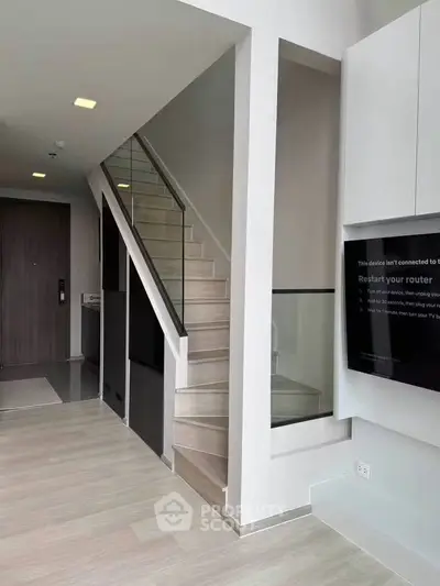 Modern duplex interior with sleek staircase and minimalist design