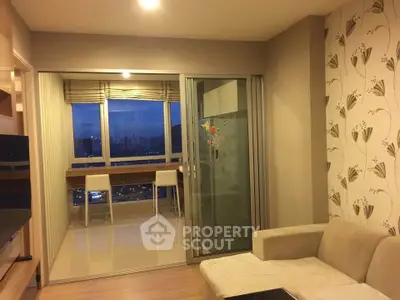 Modern living room with city view and stylish decor in high-rise apartment.