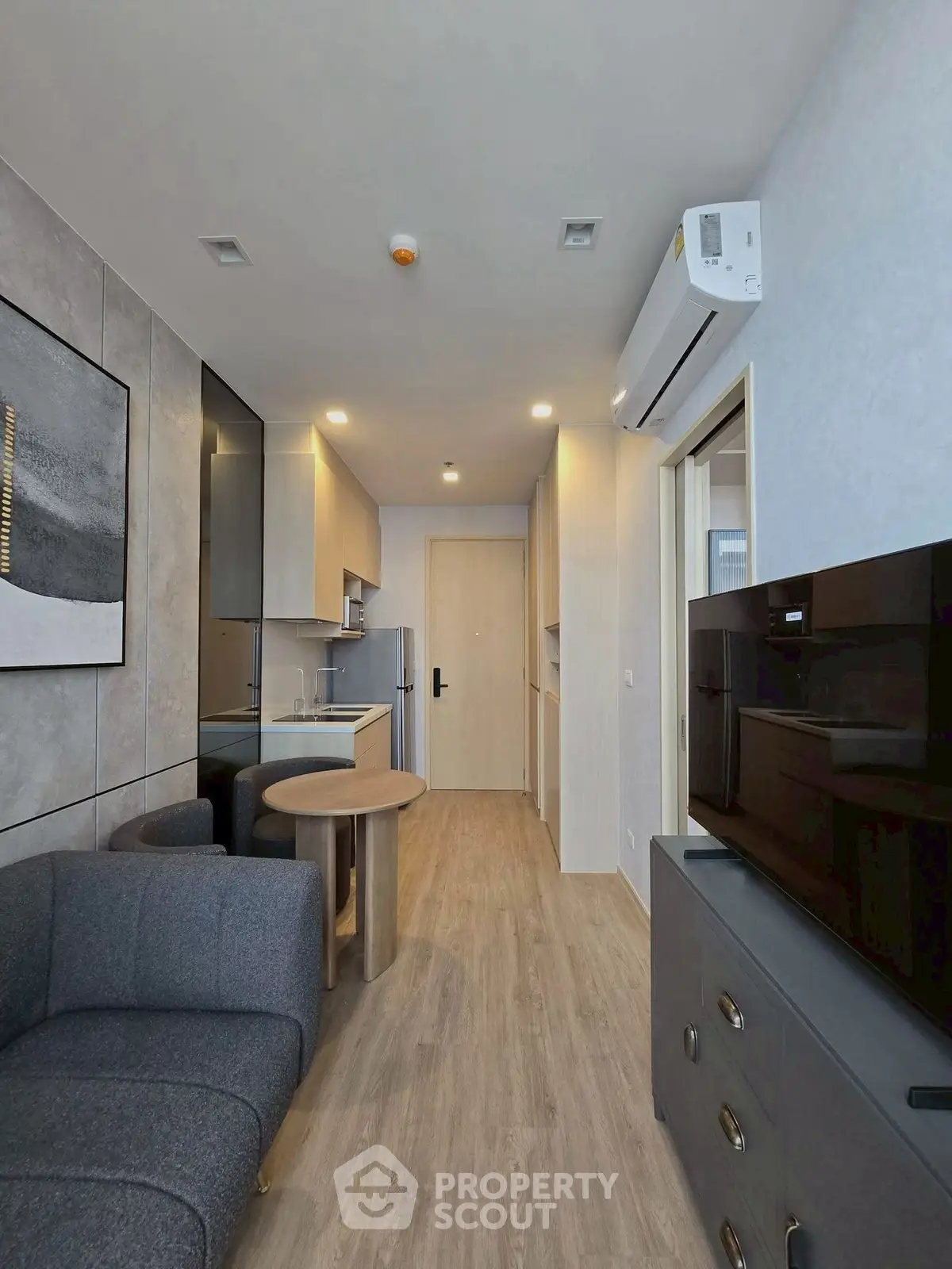 Modern apartment interior with compact kitchen and cozy living area