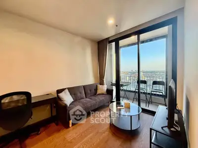 Modern living room with balcony view, stylish furniture, and ample natural light in urban apartment.
