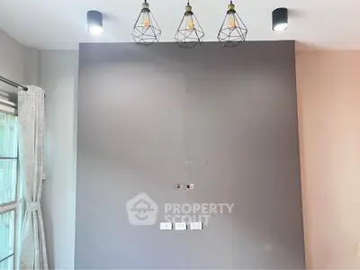 Modern interior wall with stylish lighting fixtures and window view