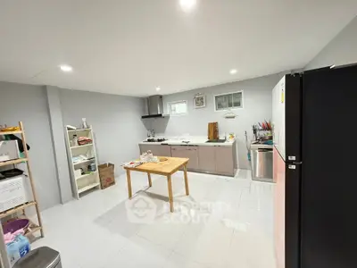 Spacious modern kitchen with sleek cabinetry and ample storage space.