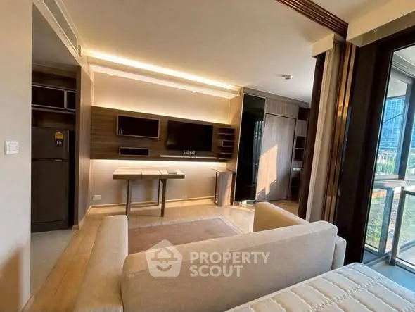 Modern living room with sleek design and large windows offering natural light and city views.
