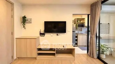 Modern living room with wall-mounted TV and open kitchen layout