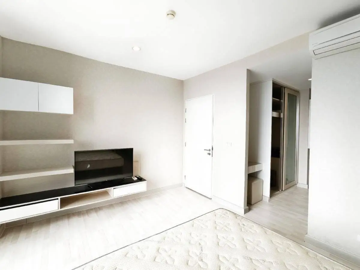 Modern minimalist living room with sleek TV unit and air conditioning