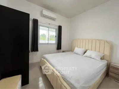 Spacious bedroom with modern furnishings and natural light