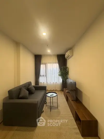 Modern living room with cozy sofa, TV, and air conditioning in a stylish apartment.