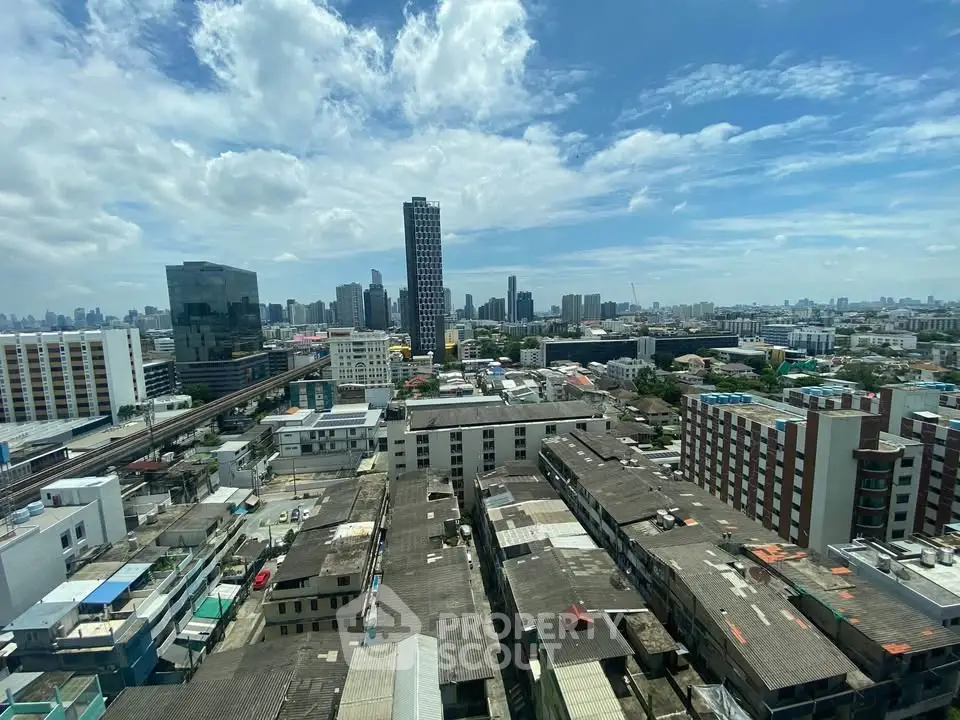 Stunning cityscape view showcasing urban skyline and residential buildings under a clear blue sky.