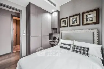 Modern bedroom with stylish decor and built-in storage in a contemporary apartment.