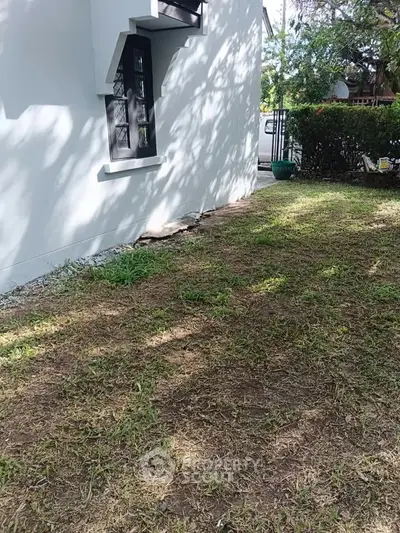 Charming garden space with lush greenery and modern building exterior