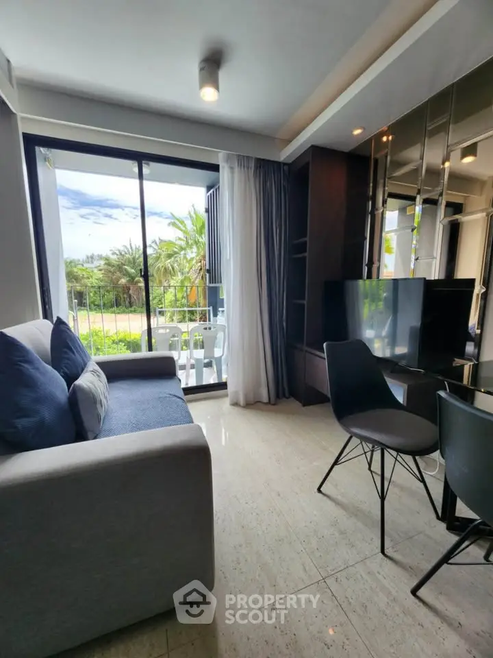 Modern living room with large window and garden view, featuring stylish furniture and elegant decor.