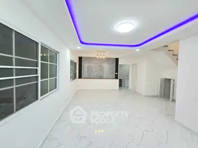Spacious modern living room with elegant lighting and marble flooring