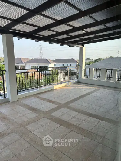 Spacious balcony with tiled flooring and scenic neighborhood view, perfect for outdoor relaxation.