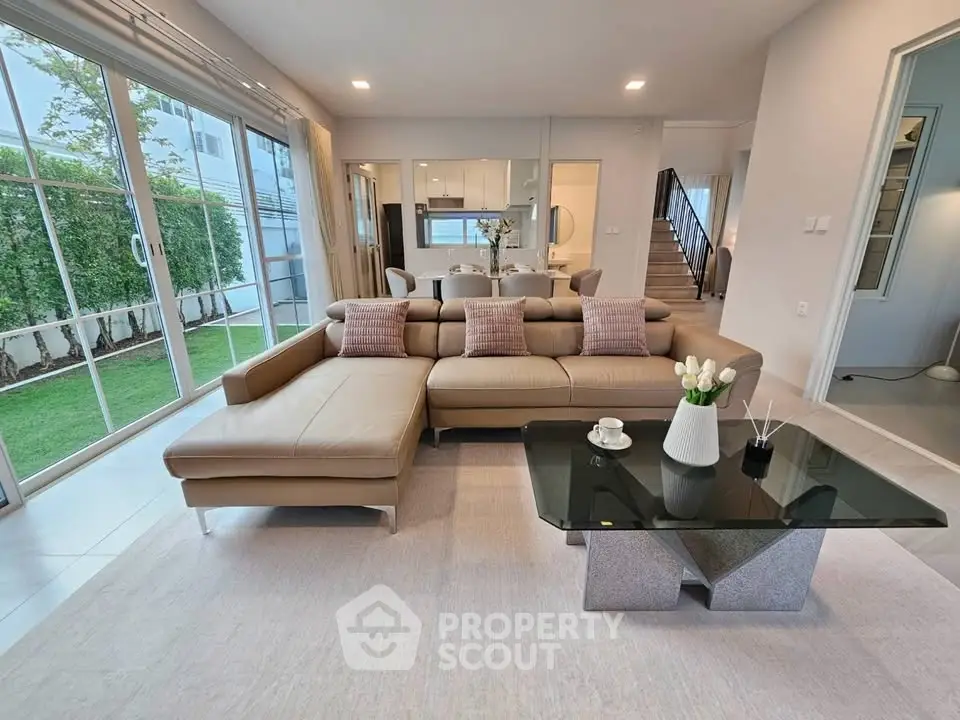 Spacious modern living room with large windows and garden view