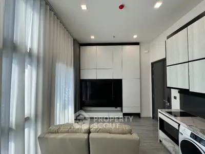 Modern living room with sleek cabinetry and natural light