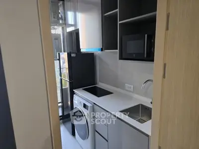 Modern compact kitchen with sleek appliances and efficient layout