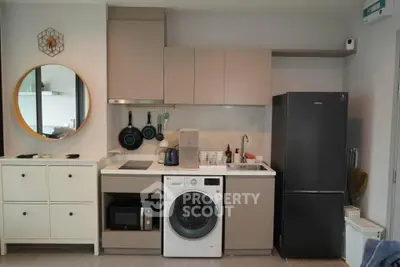 Modern compact kitchen with integrated washing machine and sleek appliances