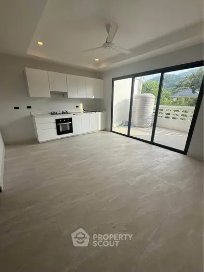 Modern open-layout kitchen with balcony view and sleek design