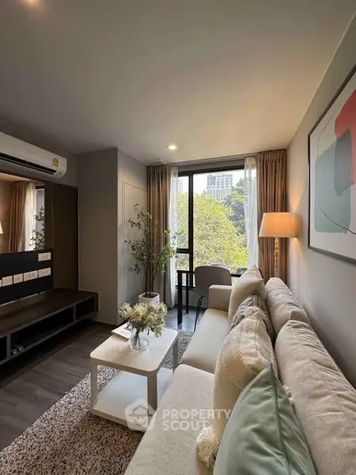 Modern living room with large window and stylish decor in urban apartment.