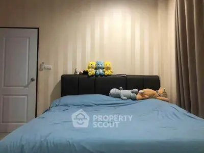 Cozy bedroom with plush toys on a stylish bed, perfect for relaxation.