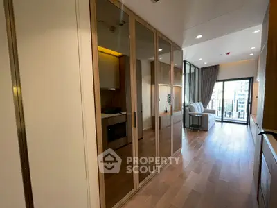 Modern apartment interior with mirrored wardrobe and balcony view