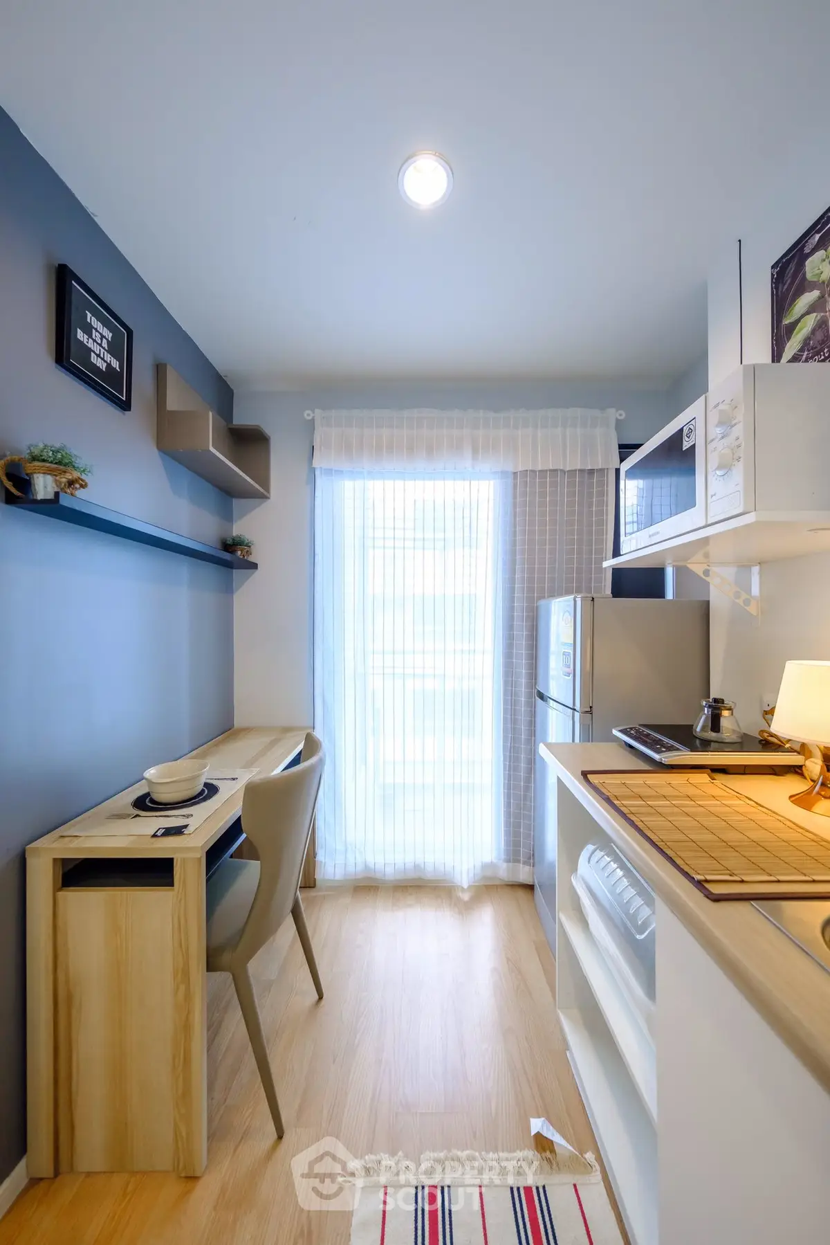 Modern compact kitchen with sleek design and natural light