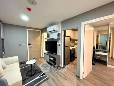 Modern living room with sleek design and integrated kitchen appliances