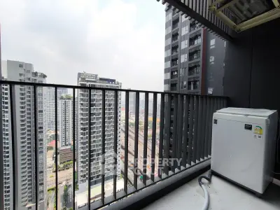 Modern high-rise balcony with city skyline view and outdoor appliance.