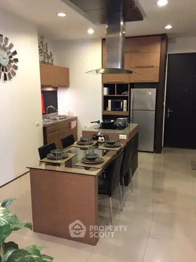 Modern kitchen with sleek wooden cabinetry and dining area in stylish apartment.