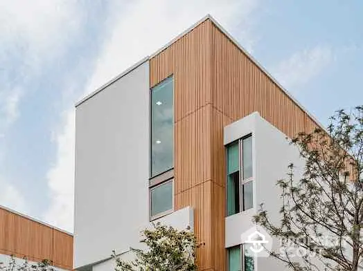 Modern architectural building with wooden paneling and large windows