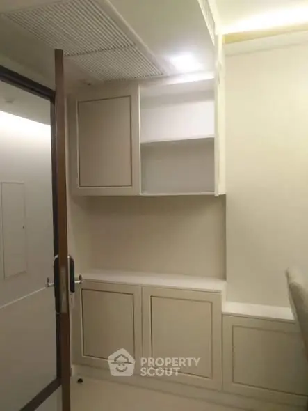 Modern storage area with sleek cabinetry and neutral tones