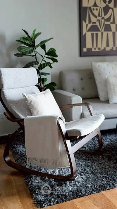 Cozy living room with modern rocking chair and plush sofa