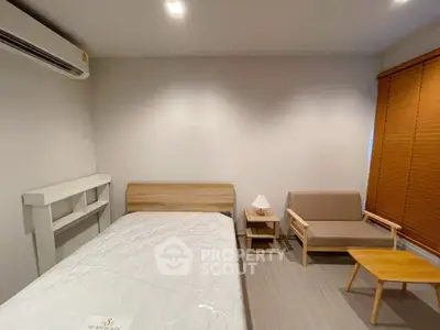 Cozy bedroom with modern furniture and natural light, perfect for relaxation and comfort.