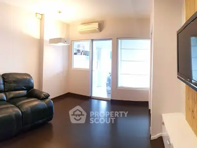 Spacious living room with modern decor and large window