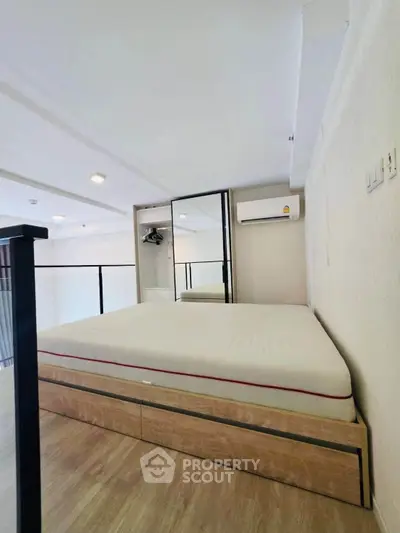 Modern bedroom with loft-style design and sleek wooden flooring