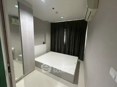 Modern minimalist bedroom with sleek design and ample natural light