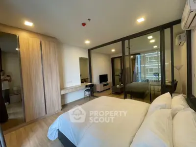 Modern bedroom with glass partition and cozy decor in a stylish apartment