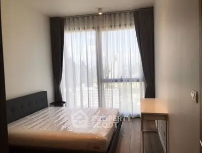 Modern bedroom with large window and city view, featuring minimalist design and natural light.