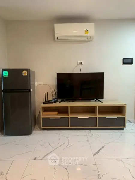 Modern living room with sleek TV unit and air conditioning